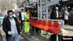 Iranians wear face masks as public areas are disinfected in Orumieh.