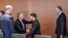 US special envoy Steve Witkoff and Ukrainian President Volodymyr Zelenskyy (center) greet each other in Berlin on December 14. German Chancellor Friedrich Merz is on Zelenskyy's right.