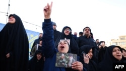 People mourn the death of Iran's Supreme Leader Ayatollah Ali Khamenei, who was killed in joint US and Israeli strikes, at a square in Tehran on March 1.