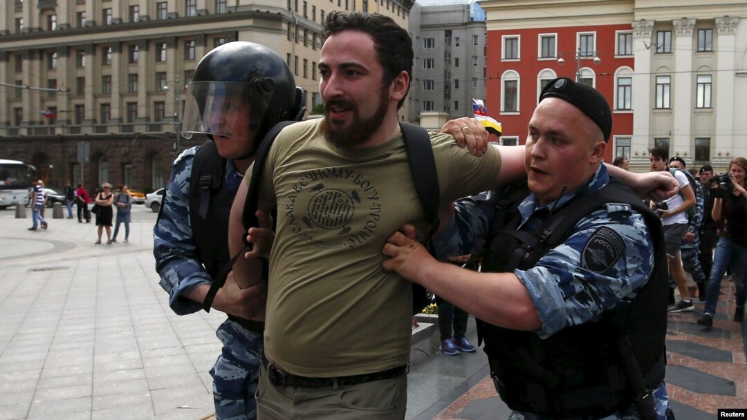 Police detain Dmitry Tsorionov, known by the nickname Dmitry Enteo, leader of the Orthodox group God's Will, after his supporters fought with gay-rights activists during an LGBT community rally in central Moscow on May 30.