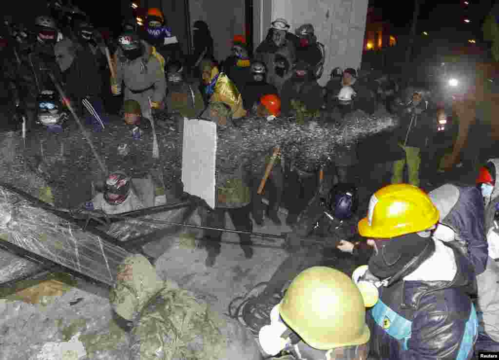 Police spray water at antigovernment protesters.