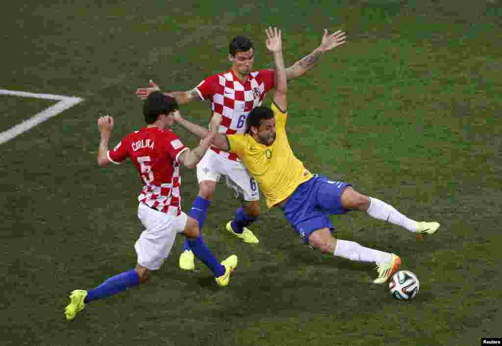 Brazil -- Brazil's Fred is fouled by Croatia's Dejan Lovren inside the area during their 2014 World Cup opening match at the Corinthians arena in Sao Paulo, June 12, 2014