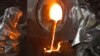 Workers pour molten gold from a crucible into moulds at the Kumtor gold mine.