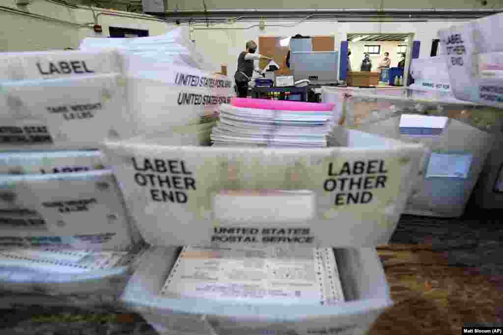 Chester County election workers scan mail-in and absentee ballots for the 2020 general election in the United States at West Chester University, Wednesday, Nov. 4, 2020, in West Chester, Pa.