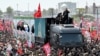 Mourners gather around the vehicle transporting the caskets of slain Iranian Supreme Leader Ali Khamenei and family members during their funeral procession in Tehran on July 6. 