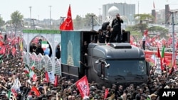 Mourners gather around the vehicle transporting the caskets of slain Iranian Supreme Leader Ali Khamenei and family members during their funeral procession in Tehran on July 6. 