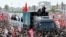 Mourners gather around the vehicle transporting the caskets of slain Iranian Supreme Leader Ali Khamenei and family members during their funeral procession in Tehran on July 6. 