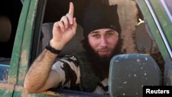 A fighter gestures outside the Syrian town of Kobani after Islamic State took control of the area on October 7.