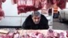 Georgia -- A vendor sells meat for the New Year meal on a street market in Tbilisi, 29Dec2009