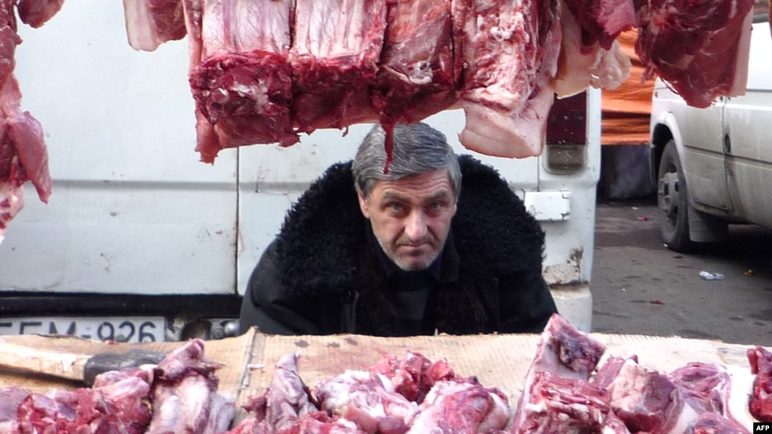 Georgia -- A vendor sells meat for the New Year meal on a street market in Tbilisi, 29Dec2009