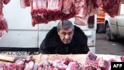 Georgia -- A vendor sells meat for the New Year meal on a street market in Tbilisi, 29Dec2009