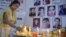 An Indian journalist lights candles during a vigil for Afghan journalists killed in a targeted earlier this year. 