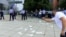 Protesters gathered outside the main government building in Pristina, where they threw away cardboard keys to symbolize the lost business they've suffered due to the restrictions.