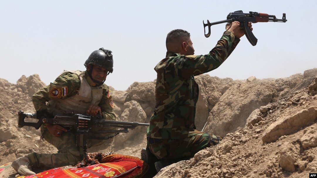Iraqi soldiers fire toward Islamic State (IS) militants outside Ramadi on May 19. An Iraqi soldier describes how he and his comrades were left isolated in Ramadi.
