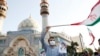 Supporters of Iranian presidential candidate Ebrahim Raisi -- the overwhelming favorite in the race -- at a campaign rally in Tehran. The hard-line candidate was one of the Iranian judges in 1988 who oversaw hundreds of speedy trials in which thousands of political prisoners were sentenced to death.&nbsp;