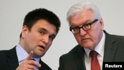 German Foreign Minister Frank-Walter Steinmeier (right) and Ukrainian Foreign Minister Pavlo Klimkin attend a news conference in Kyiv on February 23.