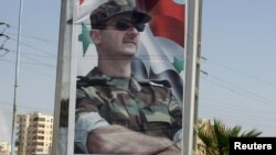 A picture of Syrian President Bashar al-Assad is seen at one of the entrances to the city of Homs in mid-June.