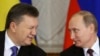 Then-Ukrainian President Viktor Yanukovych (left) gives a wink to Russian President Vladimir Putin during a signing ceremony after a meeting of the Russian-Ukrainian Interstate Commission at the Kremlin on December 17, 2013.