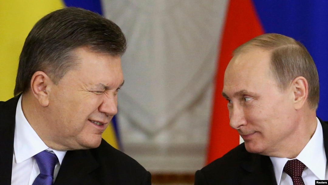 Then-Ukrainian President Viktor Yanukovych (left) gives a wink to Russian President Vladimir Putin during a signing ceremony after a meeting of the Russian-Ukrainian Interstate Commission at the Kremlin on December 17, 2013.