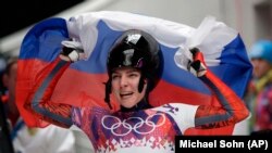 Yelena Nikitina of Russia celebrates her bronze-medal win in Sochi on February 14, 2014.