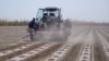 Farmer work their crop on a farm in the Andijon region of Uzbekistan. (file photo)