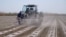 Farmer work their crop on a farm in the Andijon region of Uzbekistan. (file photo)