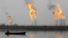 Fames rise from the burning of excess hydrocarbons at a natural gas field north of Basra.