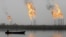 Fames rise from the burning of excess hydrocarbons at a natural gas field north of Basra.