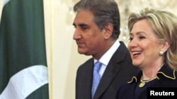 U.S. Secretary of State Hillary Clinton and her Pakistani counterpart, Shah Mehmood Qureshi, arrive for a meeting at the State Department in Washington today.