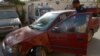 A Pakistani police officer inspects a vehicle in which a woman identified as a U.S. national was shot in Karachi on April 16.