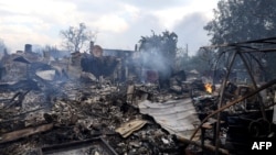 Destroyed buildings smolder in a residential area of the Kyiv suburb of Vyshneve following Russian missile and drone strikes on the Ukrainian capital on July 6. 
