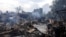 Destroyed buildings smolder in a residential area of the Kyiv suburb of Vyshneve following Russian missile and drone strikes on the Ukrainian capital on July 6. 