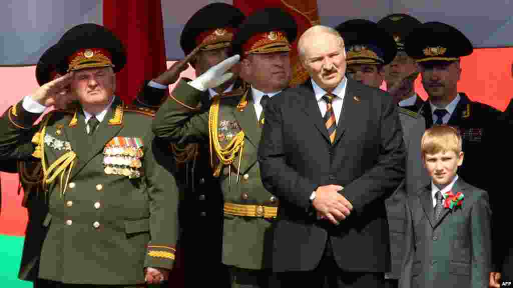 Lukashenka and Kolya watch a military parade to mark the nation&#39;s Independence Day in central Minsk in July 2012.