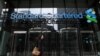 U.K. -- City workers walk past by Standard Chartered bank, London, August 7, 2012