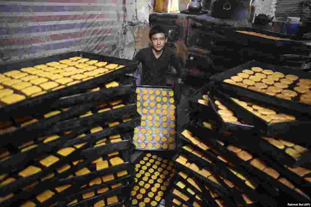 An Afghan boy makes sweets at a traditional bakery for the Eid al-Fitr holiday in Kabul on May 22.