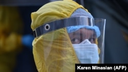 A medical worker wearing protective gear is seen outside the Grigor Lusavorich Medical Center in Yerevan on June 9.