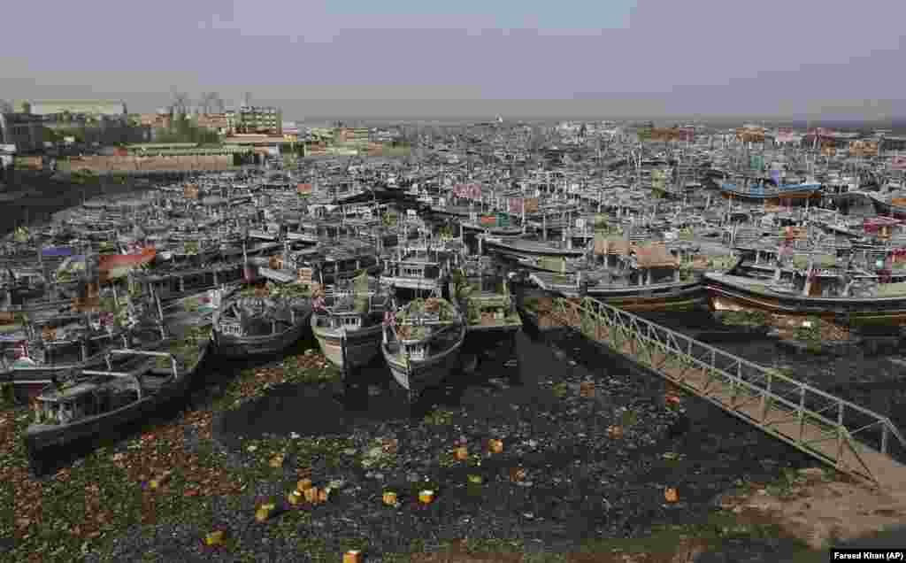 Fishing boats are anchored in a harbor after authorities called them back from sea due to Cyclone Tauktae in Karachi, Pakistan. (AP/Fareed Khan)