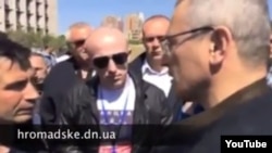 A screen grab from YouTube video showing Mikhail Khodorkovsky (right, back to camera) meeting pro-Russia separatists in Donetsk on April 27.