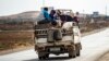 Syrian Kurdish and Arab families are pictured fleeing the border area between Syria and Turkey last week. 