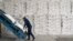 A worker stacking sacks of sugar in a distribution warehouse at the Karachay-Cherkessia Sugar Factory in Russia