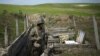 An ethnic Armenian soldier stands guard in a trench at artillery positions near the border with Nagorno-Karabakh (file photo from 2016)