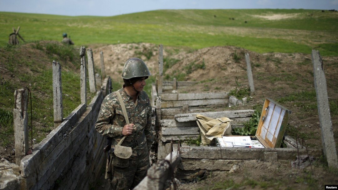 An ethnic Armenian soldier stands guard in a trench at artillery positions near the border with Nagorno-Karabakh (file photo from 2016)
