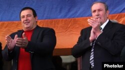 Armenia - Former President Levon Ter-Petrosian (R) and Prosperous Armenia Party leader Gagik Tsarukian greet supporters rallying in Yerevan's Liberty Square, 10Oct2014.