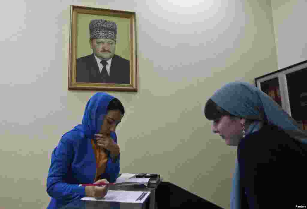 A worker signs documents at a memorial complex devoted to late President Akhmad Kadyrov.