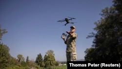 A Ukrainian border guard launches a drone he uses to survey the border to Romania looking for people who seek o cross illegally. September 2023.