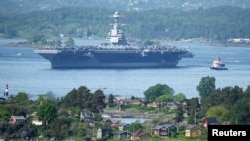 The U.S. aircraft carrier USS Gerald R. Ford sails in the Oslo Fjord, seen from Ekebergskrenten, Norway, on May 24.