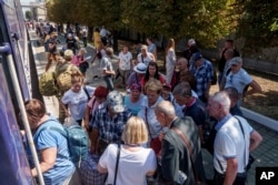 Ukrainians stand in line waiting to be evacuated by train in Pokrovsk. Authorities have started ordering civilians to leave as Russian forces close in on the city.