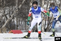 Iran's Aboulfazl Khatibi Mianaei (left) competes at the 2022 Paralympic Games in China.