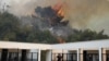A firefighter runs near caged abandoned animals near Bar, Montenegro,
