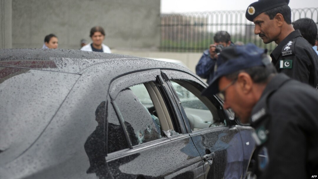 Police officials inspect the bullet-riddled car of Minorities Minister Shahbaz Bhatti following the deadly attack in Islamabad on March 2.